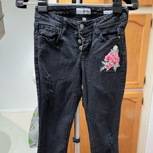 Some black jeans with a little flower patch from Black Daisy the size is 1/25